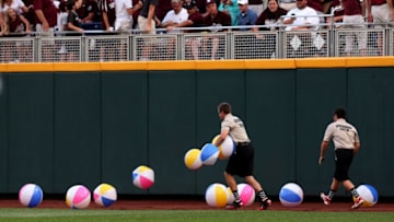 OMAHA, NE - JUNE 24: Security guards gather up beachballs that fell out of the right field bleacher crowd between innings as the UCLA Bruins play the Mississippi State Bulldogs during game one of the College World Series Finals on June 24, 2013 at TD Ameritrade Park in Omaha, Nebraska. UCLA won 3-1. (Photo by Stephen Dunn/Getty Images)