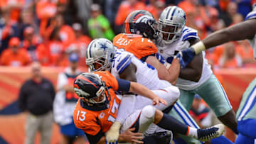 DENVER, CO - SEPTEMBER 17: Quarterback Trevor Siemian #13 of the Denver Broncos is sacked by defensive end Demarcus Lawrence #90 of the Dallas Cowboys forcing a fumble and turnover in the second quarter of a game at Sports Authority Field at Mile High on September 17, 2017 in Denver, Colorado. (Photo by Dustin Bradford/Getty Images)