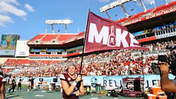 Jan 2, 2023; Tampa, FL, USA;Mississippi State Bulldogs quarterback Will Rogers (2) carries a flag after they beat Illinois Fighting Illini in honor of there head coach Mike Leach in the 2023 ReliaQuest Bowl at Raymond James Stadium. Mandatory Credit: Kim Klement-USA TODAY Sports