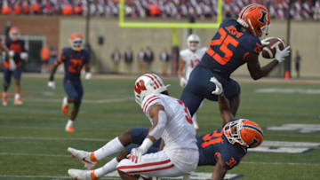 Oct 9, 2021; Champaign, Illinois, USA; Illinois Fighting Illini defensive back Kerby Joseph (25) intercepts the ball over teammate Illinois Fighting Illini defensive back Devon Witherspoon (31) and intended Wisconsin Badgers wide receiver Kendric Pryor (3) in the first half at Memorial Stadium. Mandatory Credit: Ron Johnson-USA TODAY Sports