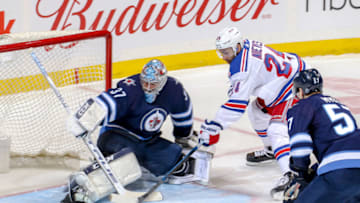 WINNIPEG, MB - FEBRUARY 12: Goaltender Connor Hellebuyck #37 of the Winnipeg Jets makes a save on Boo Nieves #24 of the New York Rangers during second period action at the Bell MTS Place on February 12, 2019 in Winnipeg, Manitoba, Canada. (Photo by Jonathan Kozub/NHLI via Getty Images)