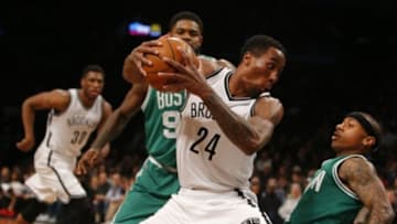 Nov 22, 2015; Brooklyn, NY, USA; Boston Celtics guard Isaiah Thomas (4) goes down defending Brooklyn Nets guard Rondae Hollis-Jefferson (24) during second half at Barclays Center. Mandatory Credit: Noah K. Murray-USA TODAY Sports