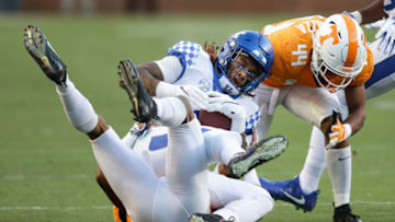 KNOXVILLE, TN - NOVEMBER 10: Lynn Bowden Jr. #1 of the Kentucky Wildcats is brought down by Cheyenne Labruzza #44 of the Tennessee Volunteers and Alontae Taylor #6 of the Tennessee Volunteers during the first half of the game between the Kentucky Wildcats and the Tennessee Volunteers at Neyland Stadium on November 10, 2018 in Knoxville, Tennessee. (Photo by Donald Page/Getty Images)