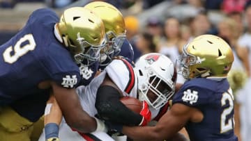 SOUTH BEND, IN - SEPTEMBER 08: Caleb Huntley #36 of the Ball State Cardinalsis dropped by (L-R) Daelin Hayes #9, Alohi Gilman #11 and Julian Love #27 of the Notre Dame Fighting Irish at Notre Dame Stadium on September 8, 2018 in South Bend, Indiana. (Photo by Jonathan Daniel/Getty Images)