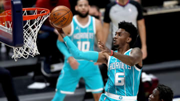 DENVER, COLORADO - MARCH 17: Jalen McDaniels #6 of the Charlotte Hornets goes to the basket against past Bol Bol #10 of the Denver Nuggets in the fourth quarter at Ball Arena on March 17, 2021 in Denver, Colorado. NOTE TO USER: User expressly acknowledges and agrees that, by downloading and or using this photograph, User is consenting to the terms and conditions of the Getty Images License Agreement. (Photo by Matthew Stockman/Getty Images)