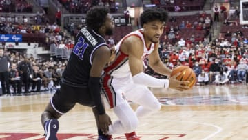 Nov 12, 2021; Columbus, Ohio, USA; Ohio State Buckeyes forward Justice Sueing (14) is knocked to the floor by Niagara Purple Eagles guard Noah Thomasson (21) in the second half at Value City Arena. Mandatory Credit: Greg Bartram-USA TODAY Sports