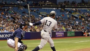 Apr 17, 2015; St. Petersburg, FL, USA; New York Yankees designated hitter Alex Rodriguez (13) hits a 2-run home run during the sixth inning against the Tampa Bay Rays at Tropicana Field. Mandatory Credit: Kim Klement-USA TODAY Sports
