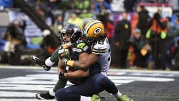 January 18, 2015; Seattle, WA, USA; Seattle Seahawks wide receiver Jermaine Kearse (15) catches a 35 yard pass from quarterback Russell Wilson (not pictured) for the game winning touchdown ahead of Green Bay Packers cornerback Tramon Williams (38) during the overtime period in the NFC Championship game at CenturyLink Field. Mandatory Credit: Kyle Terada-USA TODAY Sports