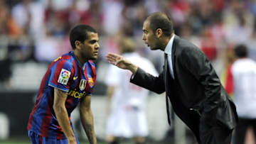 Barcelona's coach Pep Guardiola (R) speaks with Barcelona's Brazilian defender Dani Alves (L) during their Spanish league football match beetwen Sevilla and Barcelona at Sanchez Pizjuan stadium in Sevilla on May 8, 2010. AFP PHOTO / JAVIER SORIANO (Photo credit should read JAVIER SORIANO/AFP/Getty Images)