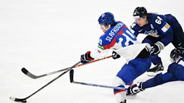 Finland's forward Mikael Granlund (top R) and Finland's forward Marko Anttila (bottom R) vie for the puck with Slovakia's forward Juraj Slafkovsky during the IIHF Ice Hockey World Championships quarterfinal match between Finland and Slovakia in Tampere, Finland, on May 26, 2022. (Photo by Jonathan NACKSTRAND / AFP) (Photo by JONATHAN NACKSTRAND/AFP via Getty Images)