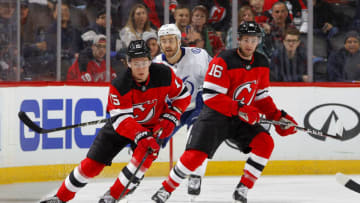NEWARK, NEW JERSEY - JANUARY 12: John Hayden #15 and Kevin Rooney #16 of the New Jersey Devils in action against the Tampa Bay Lightning at Prudential Center on January 12, 2020 in Newark, New Jersey. The Devils defeated the Lightning 3-1. (Photo by Jim McIsaac/Getty Images)