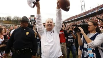 Nov 28, 2015; Charlottesville, VA, USA; Virginia Tech Hokies head coach Frank Beamer salutes Hokies fans in the stands while leaving the field with the game ball after the Hokies