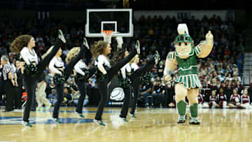 SPOKANE, WA - MARCH 22: Michigan State Spartans mascot, Sparty, and cheerleaders perform in their game against the Harvard Crimson during the Third Round of the 2014 NCAA Basketball Tournament at Spokane Veterans Memorial Arena on March 22, 2014 in Spokane, Washington. (Photo by Stephen Dunn/Getty Images)