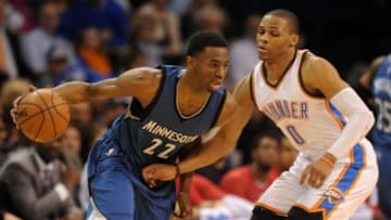 Jan 26, 2015; Oklahoma City, OK, USA; Minnesota Timberwolves forward Andrew Wiggins (22) dribbles the ball as Oklahoma City Thunder guard Russell Westbrook (0) defends during the third quarter at Chesapeake Energy Arena. Mandatory Credit: Mark D. Smith-USA TODAY Sports