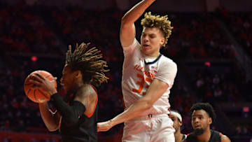 Jan 6, 2022; Champaign, Illinois, USA; Maryland Terrapins guard Fatts Russell (4) pulls down a rebound from Illinois Fighting Illini forward Coleman Hawkins (33) during the first half at State Farm Center. Mandatory Credit: Ron Johnson-USA TODAY Sports
