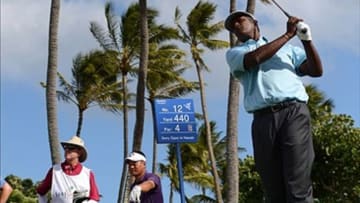 Jan 10, 2013; Honolulu, HI, USA; Vijay Singh (right) tees off on the 12th hole during the first round of the Sony Open at Waialae Country Club. Mandatory Credit: Jake Roth-USA TODAY Sports