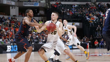 INDIANAPOLIS, IN - MARCH 10: Jarrod Uthoff #20 of the Iowa Hawkeyes drives against Malcolm Hill #21 of the Illinois Fighting Illini in the second round of the Big Ten Basketball Tournament at Bankers Life Fieldhouse on March 10, 2016 in Indianapolis, Indiana. Illinois defeated Iowa 68-66. (Photo by Joe Robbins/Getty Images)