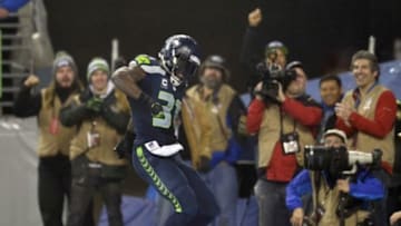 January 10, 2015; Seattle, WA, USA; Seattle Seahawks strong safety Kam Chancellor (31) celebrates after he runs the ball in for a touchdown after intercepting a pass against the Carolina Panthers during the second half in the 2014 NFC Divisional playoff football game at CenturyLink Field. Mandatory Credit: Steven Bisig-USA TODAY Sports