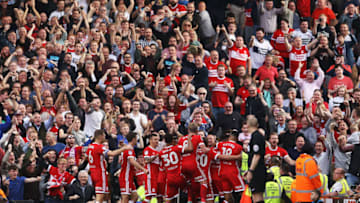 LONDON, ENGLAND - SEPTEMBER 23: Cyrus Christie of Middlesbrough is surrounded by celebrating team mates after his late equaliser during the Sky Bet Championship match between Fulham and Middlesbrough at Craven Cottage on September 23, 2017 in London, England. (Photo by Ker Robertson/Getty Images)