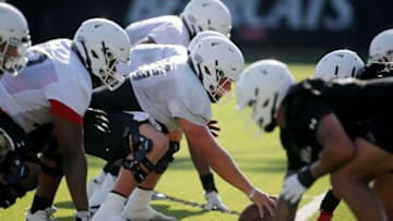 Bearcats line up before a snap during practice at the Sheakley Athletic Complex. The Enquirer.