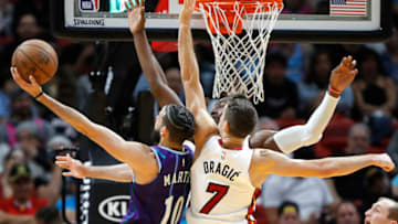Bam Adebayo #13 and Goran Dragic #7 of the Miami Heat defend a shot by Caleb Martin #10 of the Charlotte Hornets (Photo by Michael Reaves/Getty Images)