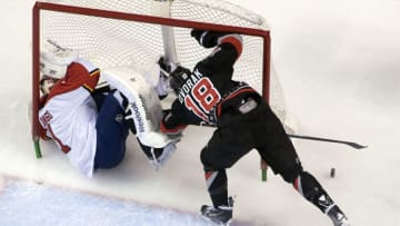 SUNRISE, FL - MARCH 27: Radek Dvorak #18 of the Carolina Hurricanes collides with Goaltender Roberto Luongo #1 of the Florida Panthers at the BB&T Center on March 27, 2014 in Sunrise, Florida. (Photo by Eliot J. Schechter/NHLI via Getty Images)