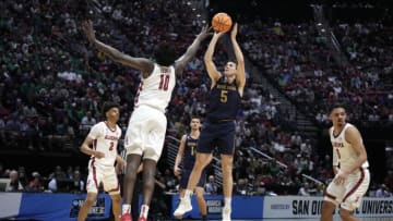 Mar 18, 2022; San Diego, CA, USA; Notre Dame Fighting Irish guard Cormac Ryan (5) shoots against Alabama Crimson Tide center Charles Bediako (10) in the first half during the first round of the 2022 NCAA Tournament at Viejas Arena. Mandatory Credit: Kirby Lee-USA TODAY Sports