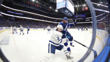 Feb 25, 2020; Tampa, Florida, USA; Tampa Bay Lightning center Steven Stamkos (91) defends Toronto Maple Leafs defenseman Justin Holl (3) on the boards during the first period at Amalie Arena. Mandatory Credit: Kim Klement-USA TODAY Sports