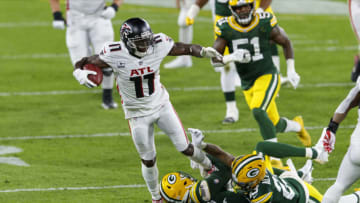 Oct 5, 2020; Green Bay, Wisconsin, USA; Atlanta Falcons wide receiver Julio Jones (11) is tackled after catching a pass during the second quarter against the Green Bay Packers at Lambeau Field. Mandatory Credit: Jeff Hanisch-USA TODAY Sports