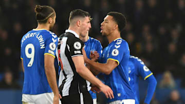 Newcastle United's Swiss defender Fabian Schar (C) and Everton's English defender Mason Holgate (R) clash during the English Premier League football match between Everton and Newcastle United at Goodison Park in Liverpool, north west England on March 17, 2022. - RESTRICTED TO EDITORIAL USE. No use with unauthorized audio, video, data, fixture lists, club/league logos or 'live' services. Online in-match use limited to 120 images. An additional 40 images may be used in extra time. No video emulation. Social media in-match use limited to 120 images. An additional 40 images may be used in extra time. No use in betting publications, games or single club/league/player publications. (Photo by Anthony Devlin / AFP) / RESTRICTED TO EDITORIAL USE. No use with unauthorized audio, video, data, fixture lists, club/league logos or 'live' services. Online in-match use limited to 120 images. An additional 40 images may be used in extra time. No video emulation. Social media in-match use limited to 120 images. An additional 40 images may be used in extra time. No use in betting publications, games or single club/league/player publications. / RESTRICTED TO EDITORIAL USE. No use with unauthorized audio, video, data, fixture lists, club/league logos or 'live' services. Online in-match use limited to 120 images. An additional 40 images may be used in extra time. No video emulation. Social media in-match use limited to 120 images. An additional 40 images may be used in extra time. No use in betting publications, games or single club/league/player publications. (Photo by ANTHONY DEVLIN/AFP via Getty Images)