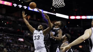 Oct 20, 2014; San Antonio, TX, USA; San Antonio Spurs power forward Boris Diaw (33) puts up a shot over Sacramento Kings power forward Jason Thompson (right) during the first half at AT&T Center. Mandatory Credit: Soobum Im-USA TODAY Sports