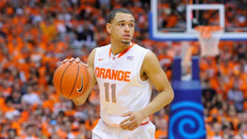 SYRACUSE, NY - FEBRUARY 15: Tyler Ennis #11 of the Syracuse Orange controls the ball against the North Carolina State Wolfpack during the first half at the Carrier Dome on February 15, 2014 in Syracuse, New York. Syracuse defeated North Carolina State 56-55. (Photo by Rich Barnes/Getty Images)
