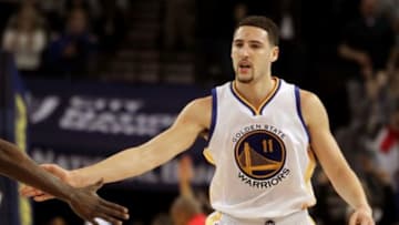 Jan 23, 2015; Oakland, CA, USA; Golden State Warriors guard Klay Thompson (11) is greeted after scoring a three point shot against the Sacramento Kings in the second half of their NBA basketball game at Oracle Arena. Mandatory Credit: Lance Iversen-USA TODAY Sports. Thompson set a record 52 points in their win over the kings.