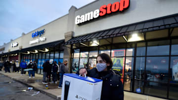 WILKES-BARRE, UNITED STATES - 2020/11/27: A man wearing a face masks leaves Game Stop with the new Play Station 5 gaming console on Black Friday. (Photo by Aimee Dilger/SOPA Images/LightRocket via Getty Images)