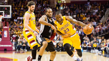 CLEVELAND, OH - JANUARY 30: Kevin Love #0 of the Cleveland Cavaliers watches as Kawhi Leonard #2 of the San Antonio Spurs puts pressure on LeBron James #23 of the Cleveland Cavaliers during the first half at Quicken Loans Arena on January 30, 2016 in Cleveland, Ohio. NOTE TO USER: User expressly acknowledges and agrees that, by downloading and/or using this photograph, user is consenting to the terms and conditions of the Getty Images License Agreement. Mandatory copyright notice. (Photo by Jason Miller/Getty Images)