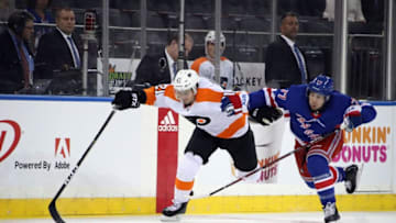 NEW YORK, NEW YORK - SEPTEMBER 19: Scott Laughton #21 of the Philadelphia Flyers and Anthony DeAngelo #77 of the New York Rangers race for the puck during the third period at Madison Square Garden on September 19, 2018 in New York City. The Flyers defeated the Rangers 6-4. (Photo by Bruce Bennett/Getty Images)