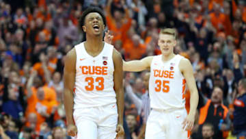 SYRACUSE, NY - FEBRUARY 20: Elijah Hughes #33 of the Syracuse Orange reacts to a made three-point basket as teammate Buddy Boeheim #35 gestures against the Louisville Cardinals during the first half at the Carrier Dome on February 20, 2019 in Syracuse, New York. (Photo by Rich Barnes/Getty Images)