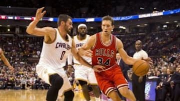 Oct 20, 2014; Columbus, OH, USA; Chicago Bulls forward Mike Dunleavy (34) dives around Cleveland Cavaliers forward Kevin Love (0) at Value City Arena. Cleveland won the game 107-98. Mandatory Credit: Greg Bartram-USA TODAY Sports