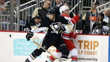 Dec 19, 2015; Pittsburgh, PA, USA; Pittsburgh Penguins center Nick Bonino (13) checks Carolina Hurricanes center Riley Nash (20) during the second period at the CONSOL Energy Center. Carolina won 2-1. Mandatory Credit: Charles LeClaire-USA TODAY Sports