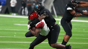 Nov 19, 2021; Paradise, Nevada, USA; UNLV Rebels linebacker Jacoby Windmon (4) tackles San Diego State Aztecs running back Greg Bell (22) during a game at Allegiant Stadium. Mandatory Credit: Stephen R. Sylvanie-USA TODAY Sports
