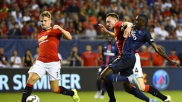 Jul 29, 2015; Chicago, IL, USA; Paris Saint-Germain midfielder Blaise Matuidi (14) scores a goal against Manchester United defender Luke Shaw (3) and defender Phil Jones (4) during the first half at Soldier Field. Mandatory Credit: Mike DiNovo-USA TODAY Sports
