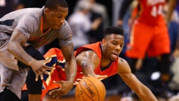 Mar 19, 2015; Phoenix, AZ, USA; New Orleans Pelicans guard Norris Cole (right) dives for a loose ball against Phoenix Suns guard Eric Bledsoe in the second half at US Airways Center. The Suns defeated the Pelicans 74-72. Mandatory Credit: Mark J. Rebilas-USA TODAY Sports