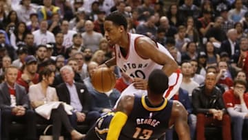 Apr 16, 2016; Toronto, Ontario, CAN; Toronto Raptors guard DeMar DeRozan (10) fouls Indiana Pacers forward Paul George (13) in game one of the first round of the 2016 NBA Playoffs at Air Canada Centre. Indiana defeated Toronto 100-90. Mandatory Credit: John E. Sokolowski-USA TODAY Sports