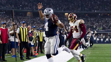 Nov 24, 2016; Arlington, TX, USA; Dallas Cowboys quarterback Dak Prescott (4) eludes Washington Redskins outside linebacker Preston Smith (94) for a touchdown during the second half at AT&T Stadium. Mandatory Credit: Jerome Miron-USA TODAY Sports