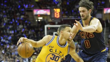 Jan 18, 2016; Cleveland, OH, USA; Golden State Warriors guard Stephen Curry (30) drives against Cleveland Cavaliers forward Kevin Love (0) in the first quarter at Quicken Loans Arena. Mandatory Credit: David Richard-USA TODAY Sports