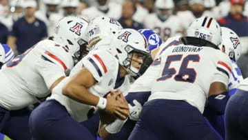 LAS VEGAS, NEVADA - SEPTEMBER 04: Quarterback Gunner Cruz #9 of the Arizona Wildcats runs behind his offensive line for a first down against the Brigham Young Cougars during the Good Sam Vegas Kickoff Classic at Allegiant Stadium on September 4, 2021 in Las Vegas, Nevada. The Cougars defeated the Wildcats 24-16. (Photo by Ethan Miller/Getty Images)