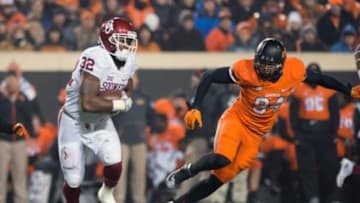 Nov 28, 2015; Stillwater, OK, USA; Oklahoma Sooners running back Samaje Perine (32) runs the ball as Oklahoma State Cowboys defensive end Jordan Brailford (94) defends during the second half at Boone Pickens Stadium. Oklahoma won 58-23. Mandatory Credit: Rob Ferguson-USA TODAY Sports