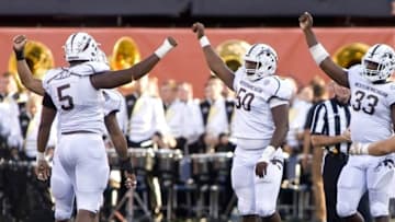 Sep 17, 2016; Champaign, IL, USA; Western Michigan Broncos defensive end Andre Turner (5), defensive lineman Daniel Jackson (50), and defensive lineman Eric Assuoa (33) celebrate after sacking Illinois Fighting Illini quarterback Wes Lunt (12) during the third quarter at Memorial Stadium. Western Michigan beat Illinois 34 to 10. Mandatory Credit: Mike Granse-USA TODAY Sports