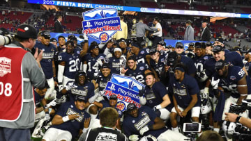 GLENDALE, AZ - DECEMBER 30: Penn State Nittany Lions players pose for a photo after beating the Washington Huskies 35-28 during the Playstation Fiesta Bowl at University of Phoenix Stadium on December 30, 2017 in Glendale, Arizona. (Photo by Norm Hall/Getty Images)