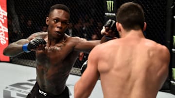 PERTH, AUSTRALIA - FEBRUARY 11: (L-R) Israel Adesanya of Nigeria punches Rob Wilkinson of Australia in their middleweight bout during the UFC 221 event at Perth Arena on February 11, 2018 in Perth, Australia. (Photo by Jeff Bottari/Zuffa LLC/Zuffa LLC via Getty Images)